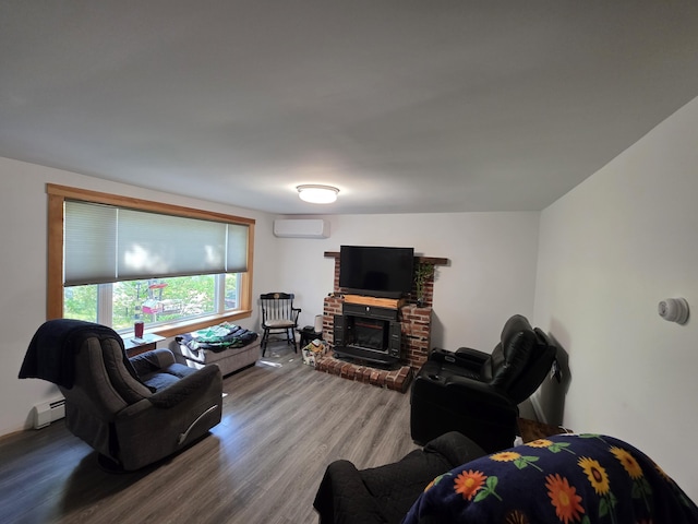 19 Resh Rd, Searsport, ME 04974 - living room with a wall mounted AC, baseboard heating, wood finished floors, and a brick fireplace