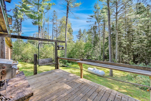 deck with grilling area and a yard