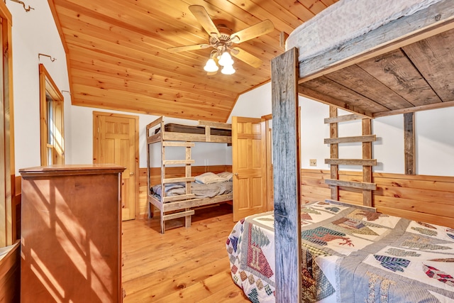 bedroom with light wood-type flooring, ceiling fan, vaulted ceiling, and wooden ceiling