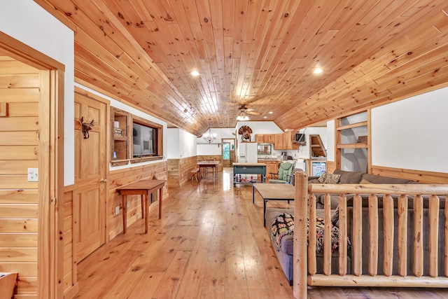 living room featuring ceiling fan, light hardwood / wood-style floors, and wooden ceiling