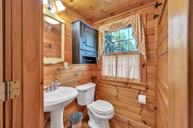 bathroom featuring wooden ceiling, toilet, and wood walls