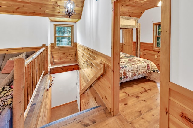 interior space featuring wood ceiling, vaulted ceiling, and wood walls