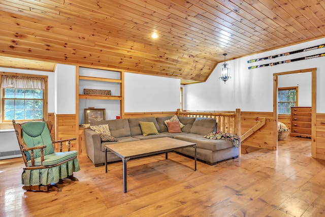 living room with wooden ceiling, lofted ceiling, a healthy amount of sunlight, and light hardwood / wood-style flooring