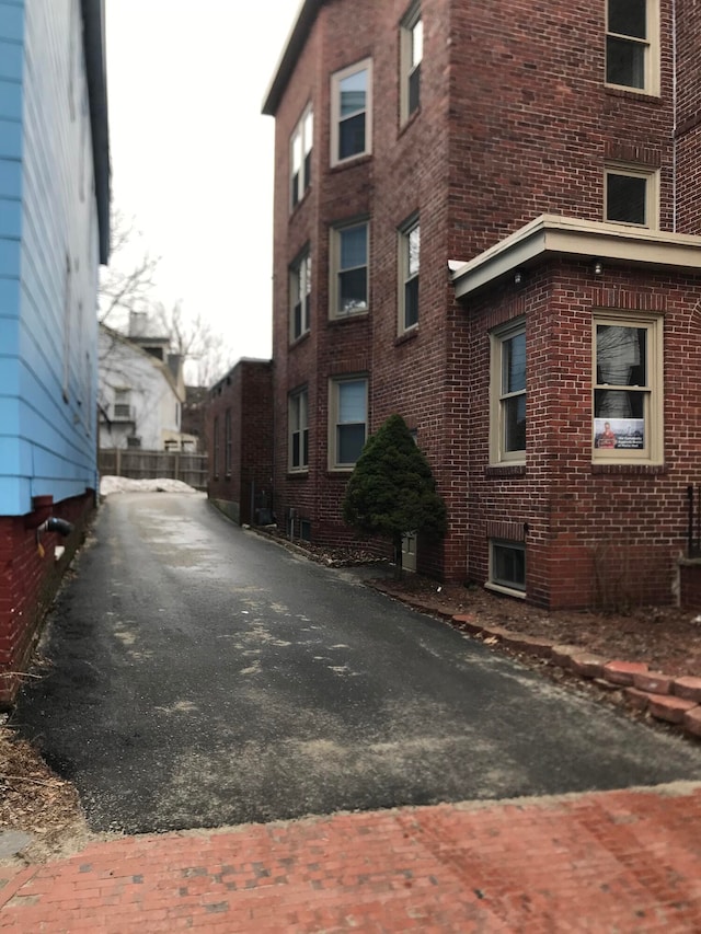 21 Dow St Unit 4, Portland, ME 04102 - view of side of home with aphalt driveway and brick siding