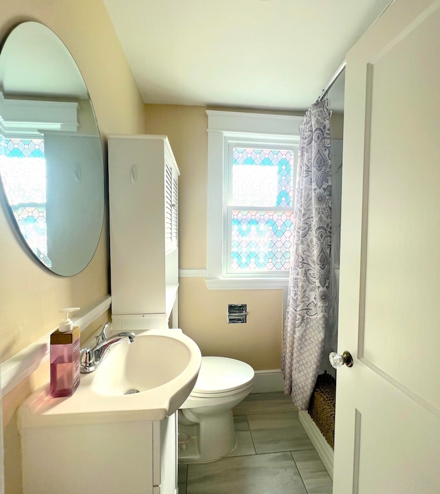 21 Dow St Unit 4, Portland, ME 04102 - bathroom featuring vanity, baseboards, toilet, and a shower with shower curtain