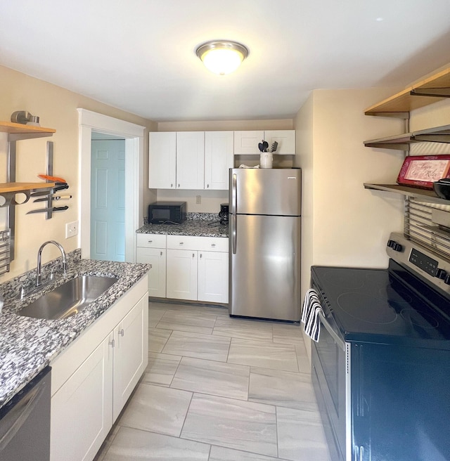 21 Dow St Unit 4, Portland, ME 04102 - kitchen featuring open shelves, stone countertops, white cabinetry, a sink, and stainless steel appliances