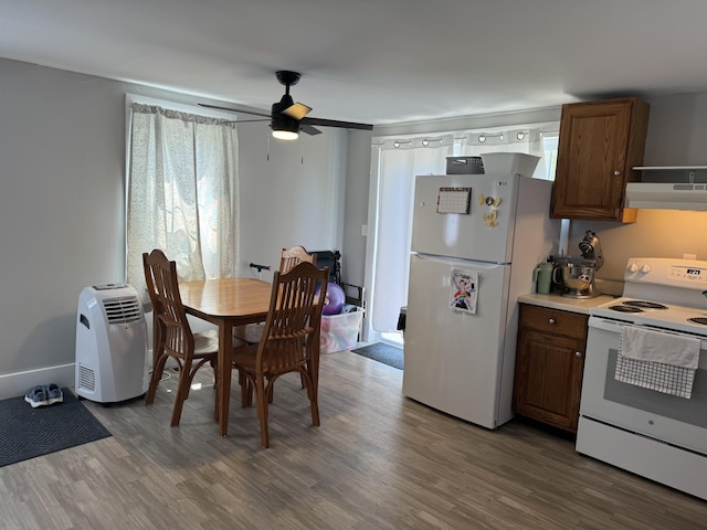 dining area with wood finished floors and ceiling fan