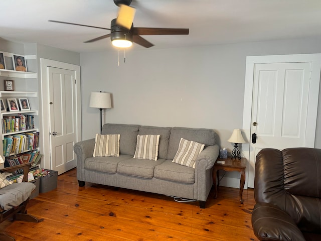 living room featuring hardwood / wood-style flooring and ceiling fan