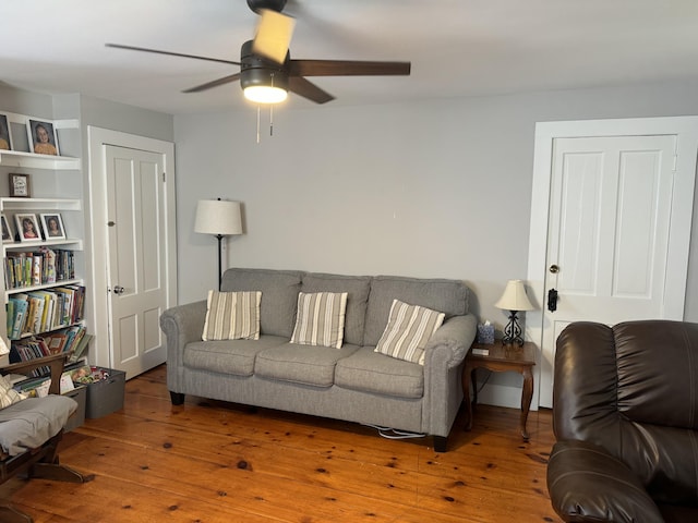living room with ceiling fan and hardwood / wood-style floors