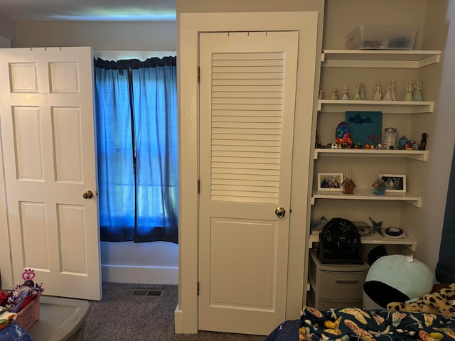 bedroom with dark colored carpet