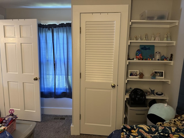 bedroom with a closet and visible vents