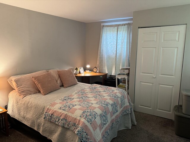 bedroom featuring a closet and dark carpet
