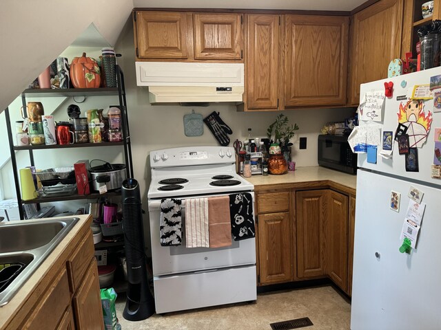 kitchen featuring light countertops, brown cabinetry, custom range hood, and white appliances