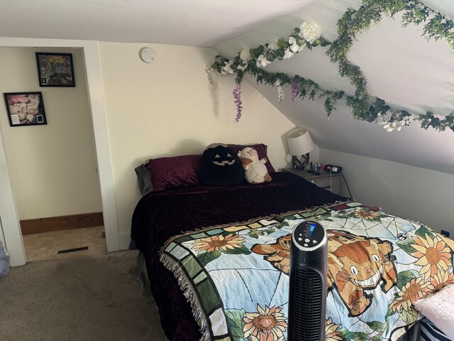 carpeted bedroom with baseboards and lofted ceiling