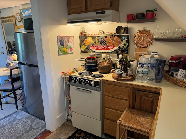 kitchen with stainless steel refrigerator and white electric range oven