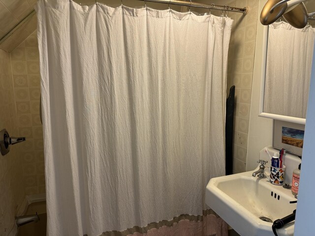 bathroom with a sink and a shower with shower curtain