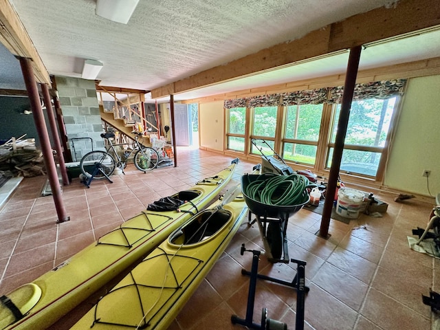 54 Harbor Hills Ln, Addison, ME 04606 - exercise room featuring a textured ceiling and tile patterned floors
