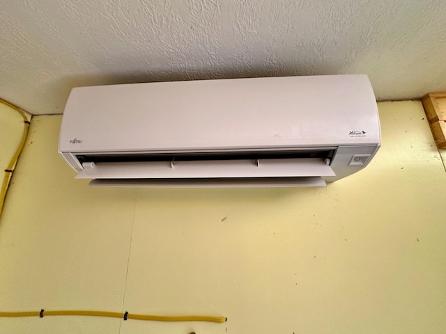54 Harbor Hills Ln, Addison, ME 04606 - detailed view of a wall mounted air conditioner and a textured ceiling