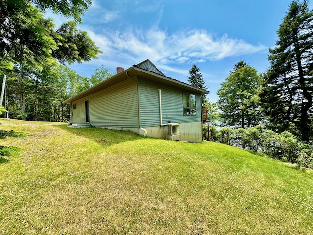 54 Harbor Hills Ln, Addison, ME 04606 - view of home's exterior featuring a chimney and a yard