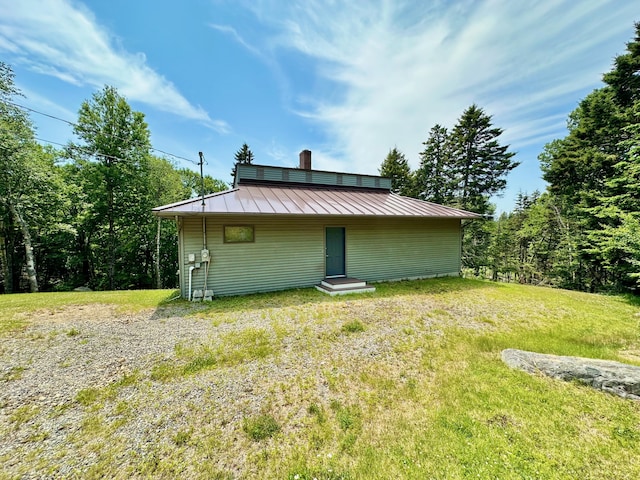 54 Harbor Hills Ln, Addison, ME 04606 - view of home's exterior with a standing seam roof, metal roof, and a chimney
