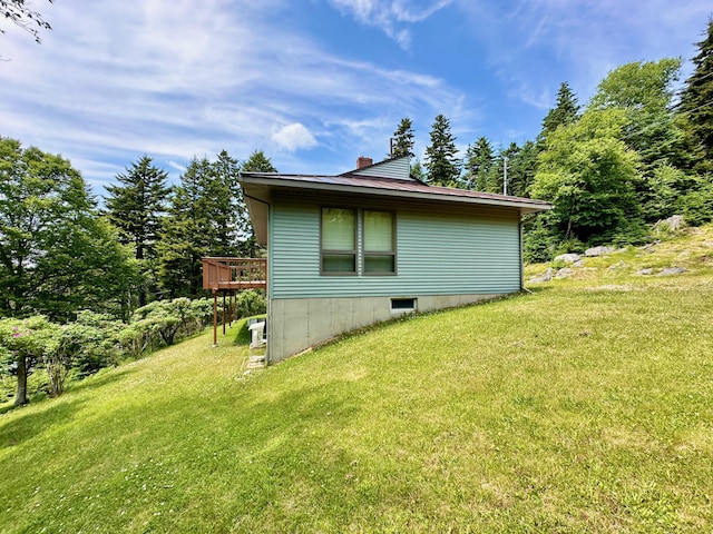 54 Harbor Hills Ln, Addison, ME 04606 - view of property exterior featuring a chimney, a lawn, and a deck