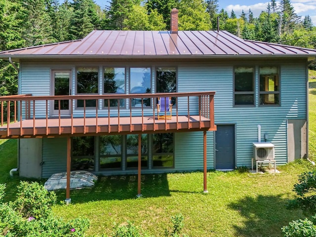 54 Harbor Hills Ln, Addison, ME 04606 - rear view of property with a standing seam roof, metal roof, a deck, and a lawn