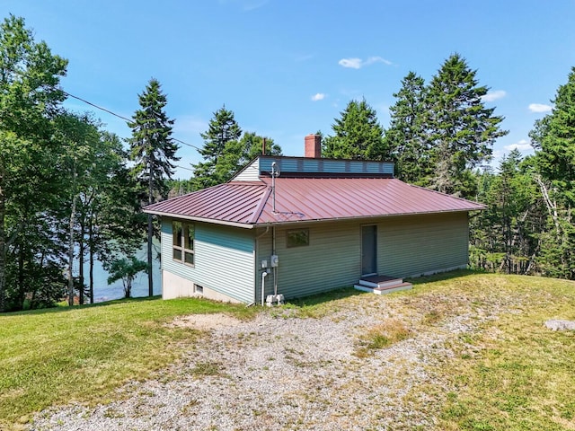 54 Harbor Hills Ln, Addison, ME 04606 - rear view of property featuring a lawn, metal roof, and a chimney