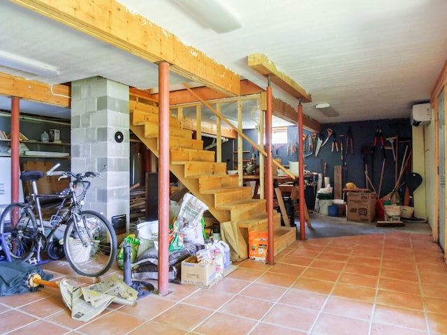 54 Harbor Hills Ln, Addison, ME 04606 - below grade area with stairway, tile patterned flooring, and a wall mounted AC