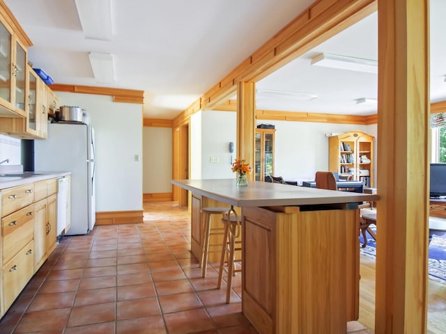 54 Harbor Hills Ln, Addison, ME 04606 - kitchen with white appliances, glass insert cabinets, light countertops, a breakfast bar, and tile patterned floors