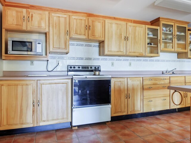 54 Harbor Hills Ln, Addison, ME 04606 - kitchen featuring range with electric cooktop, stainless steel microwave, light brown cabinetry, and tasteful backsplash