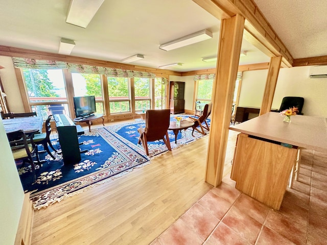 54 Harbor Hills Ln, Addison, ME 04606 - dining space with a wall mounted air conditioner and light tile patterned flooring