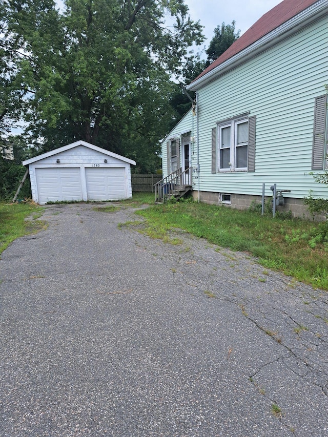 view of side of property featuring an outbuilding and a garage