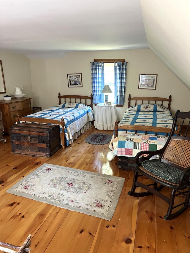 bedroom featuring lofted ceiling and wood-type flooring