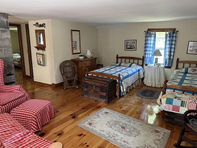 bedroom featuring hardwood / wood-style flooring and baseboards