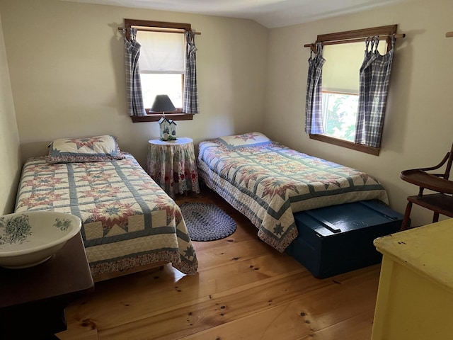 bedroom featuring vaulted ceiling and hardwood / wood-style floors