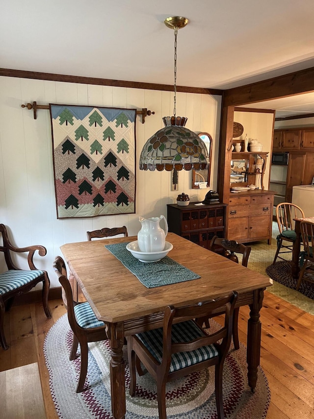 dining room with light wood finished floors and washer / dryer