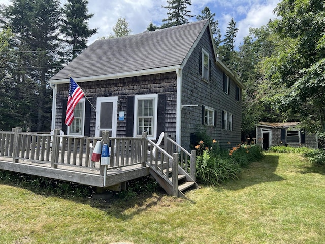 view of front of home featuring a front lawn and a wooden deck