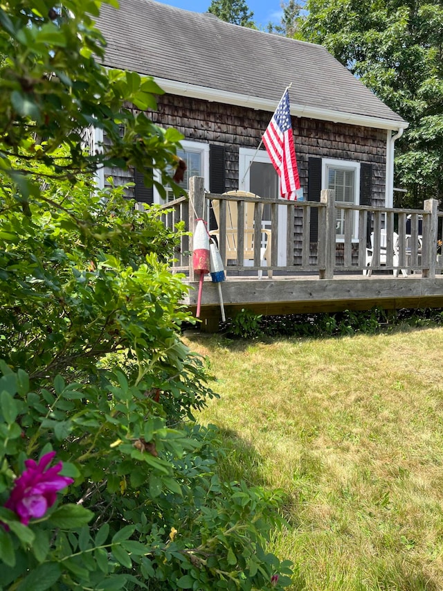 view of front of house featuring a deck and a front lawn