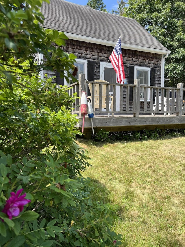 view of front of house featuring a front yard and a deck