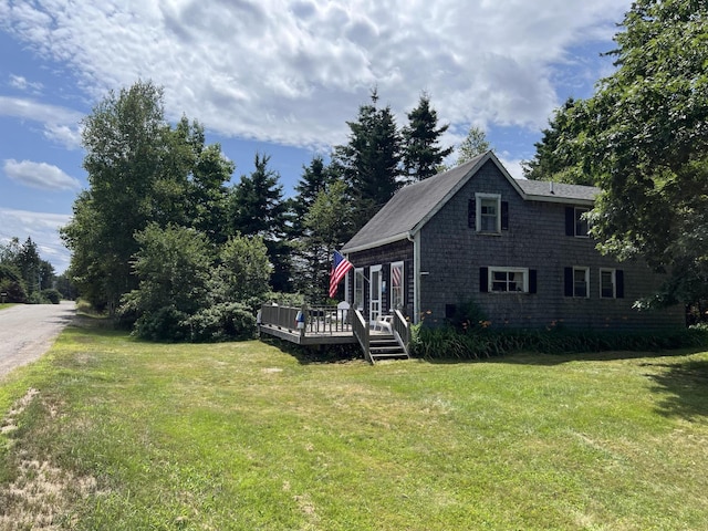 view of home's exterior featuring a deck and a yard