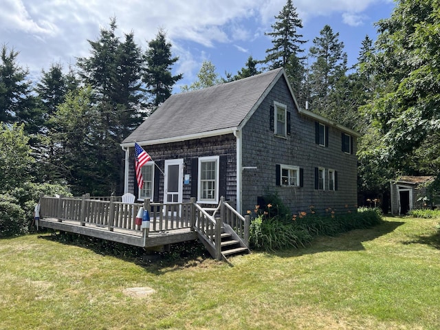 view of front facade with a deck and a front lawn