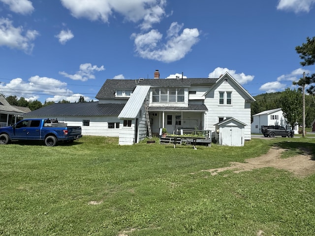 back of property featuring a lawn