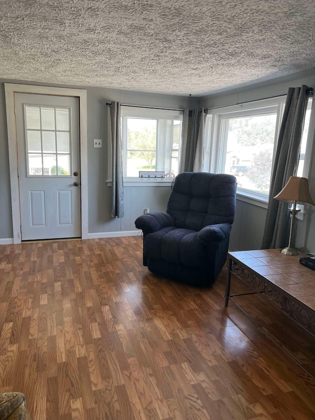 living room with hardwood / wood-style floors and a textured ceiling