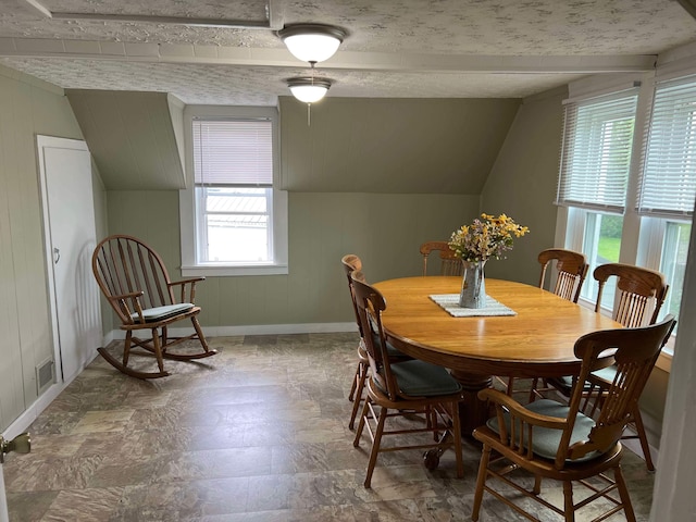 dining room featuring lofted ceiling