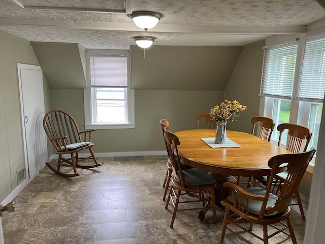 dining area with baseboards, lofted ceiling, and visible vents
