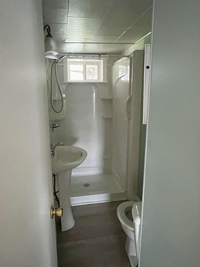 bathroom featuring toilet and walk in shower