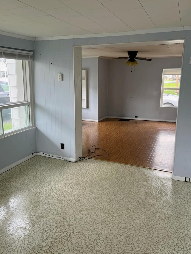 spare room featuring ceiling fan and crown molding