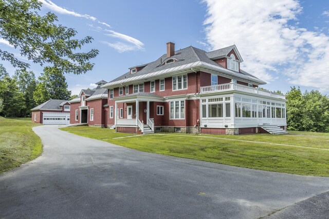 42 Fernald St, Wilton, ME 04294 - view of front of home with a garage and a front lawn