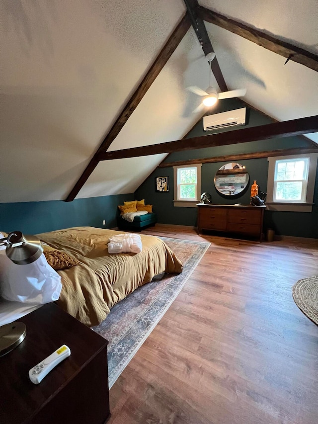 bedroom featuring an AC wall unit, multiple windows, wood-type flooring, and lofted ceiling