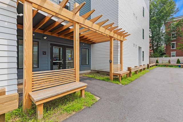 exterior space with french doors and a pergola